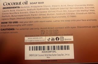 Coconut oil soap bar with label showing ingredients and usage instructions.